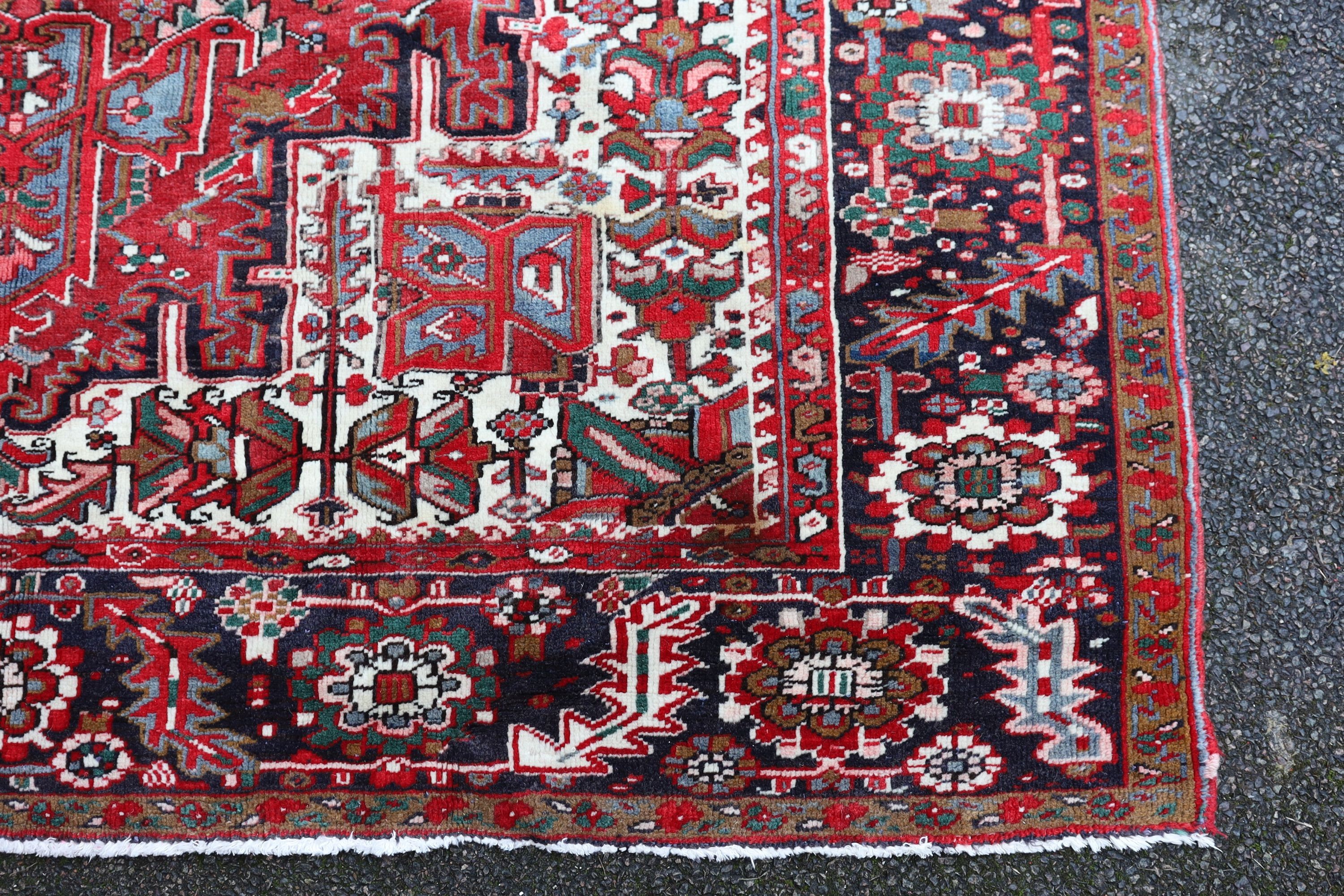 A Heriz red ground carpet, 324 x 243cm.